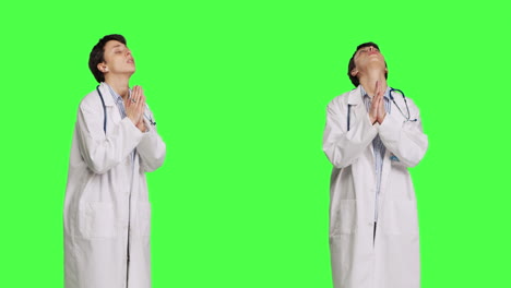 Religious-woman-physician-praying-to-jesus-christ-against-greenscreen